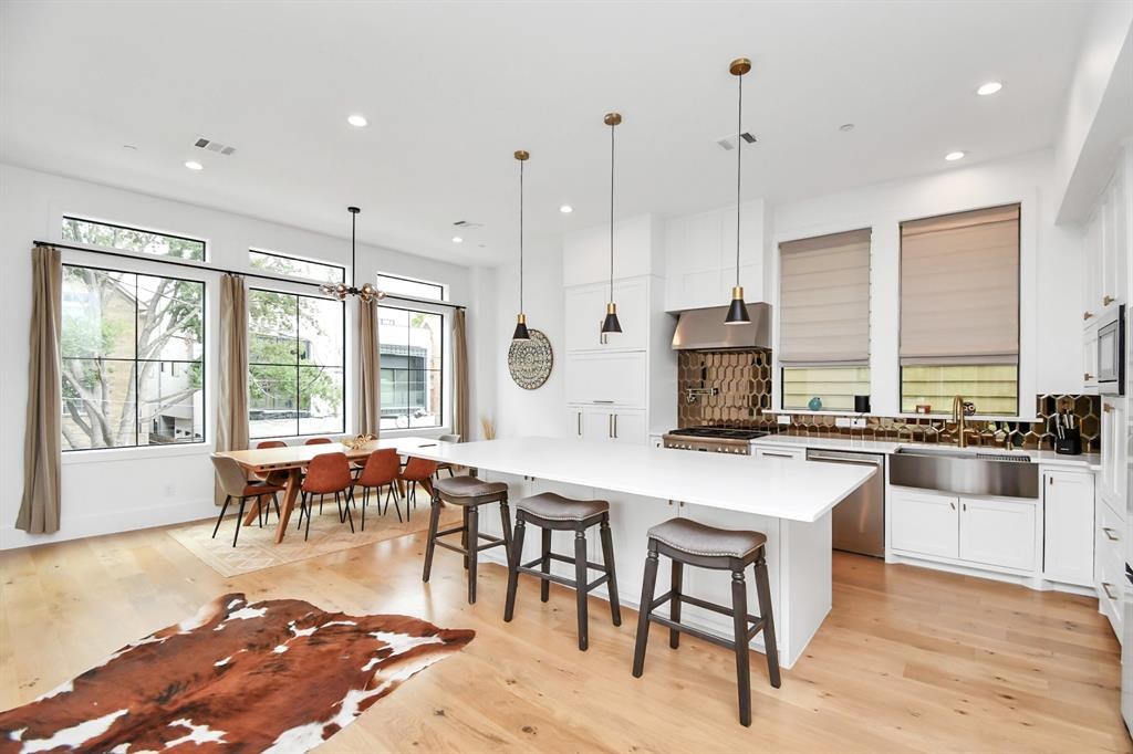 Kitchen with quartz island and designer backsplash